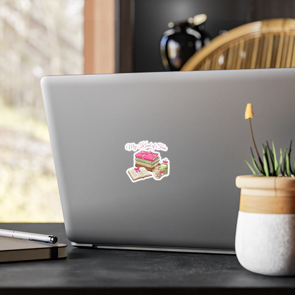 Laptop with a sticker on a desk with a plant and pen in the background