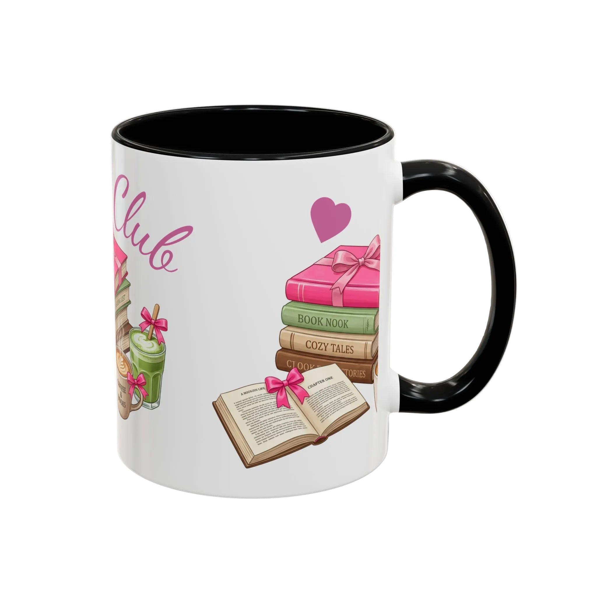 A white ceramic mug with a black handle and black interior, decorated with a book-themed illustration featuring pink, green, and brown books, an open book, and a pink heart.
