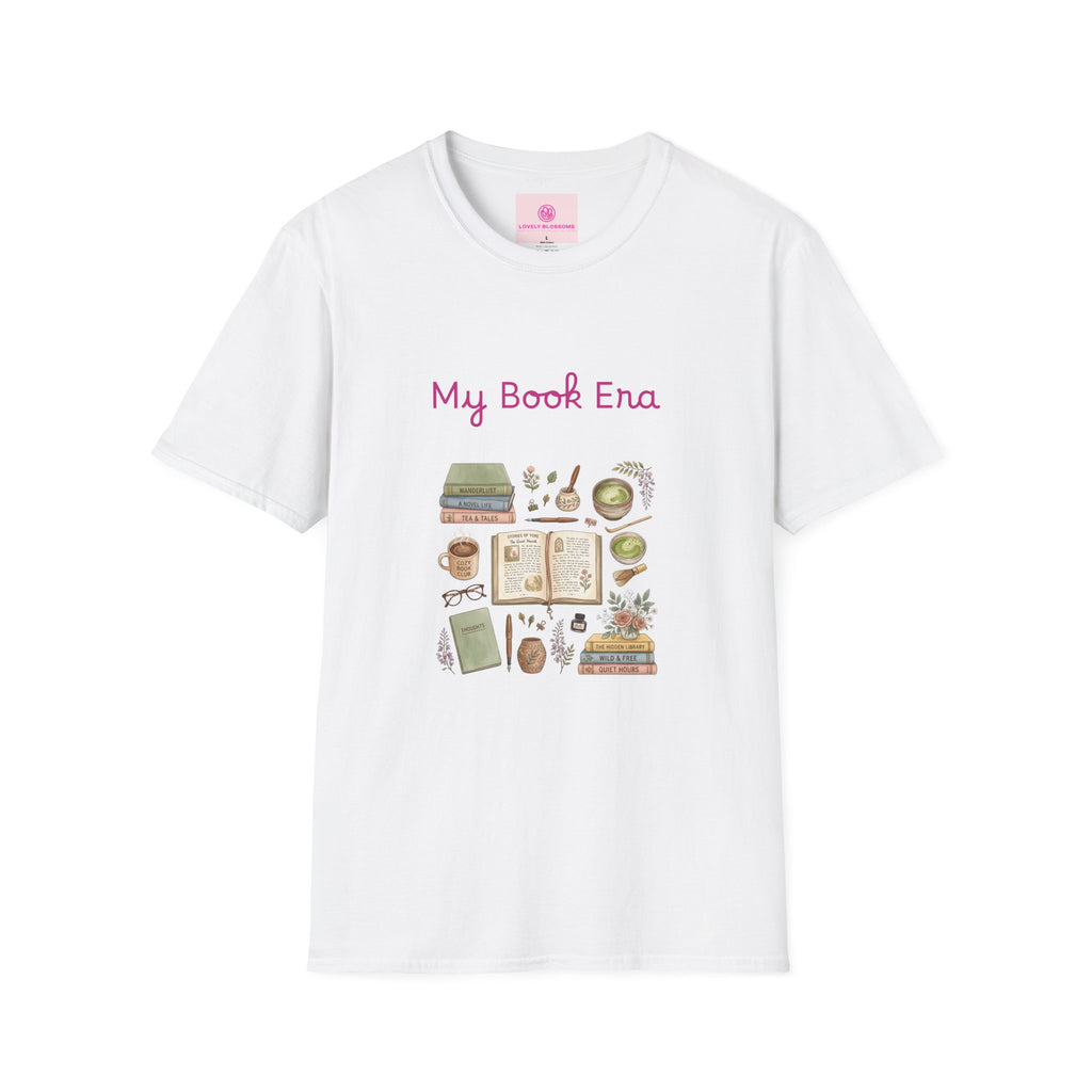 A white short-sleeve crewneck t-shirt featuring a 'My Book Era' graphic print on the front. The graphic includes pink text and a collection of cute, vintage-style illustrations related to books, including an open book, a pencil, a magnifying glass, and a bookshelf.