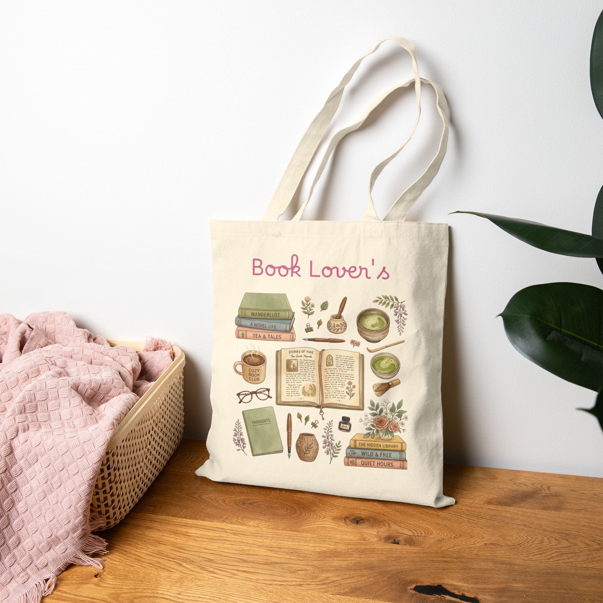 Tote bag with a design and text on a wooden surface with a plant in the background