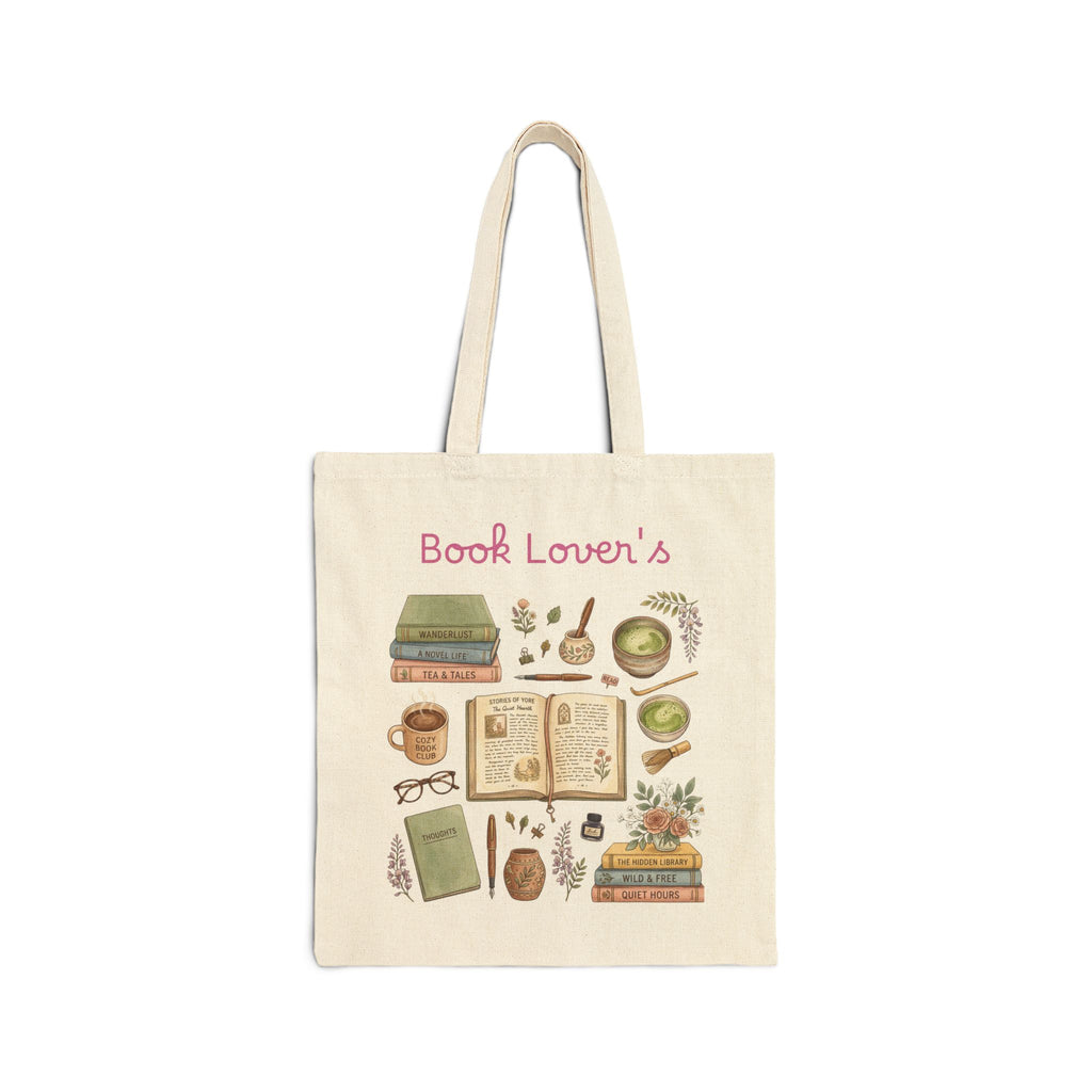 A cream canvas tote bag with a 'Book Lover's' illustration print featuring books, a mug, glasses, and botanical elements, shown on a plain white background.