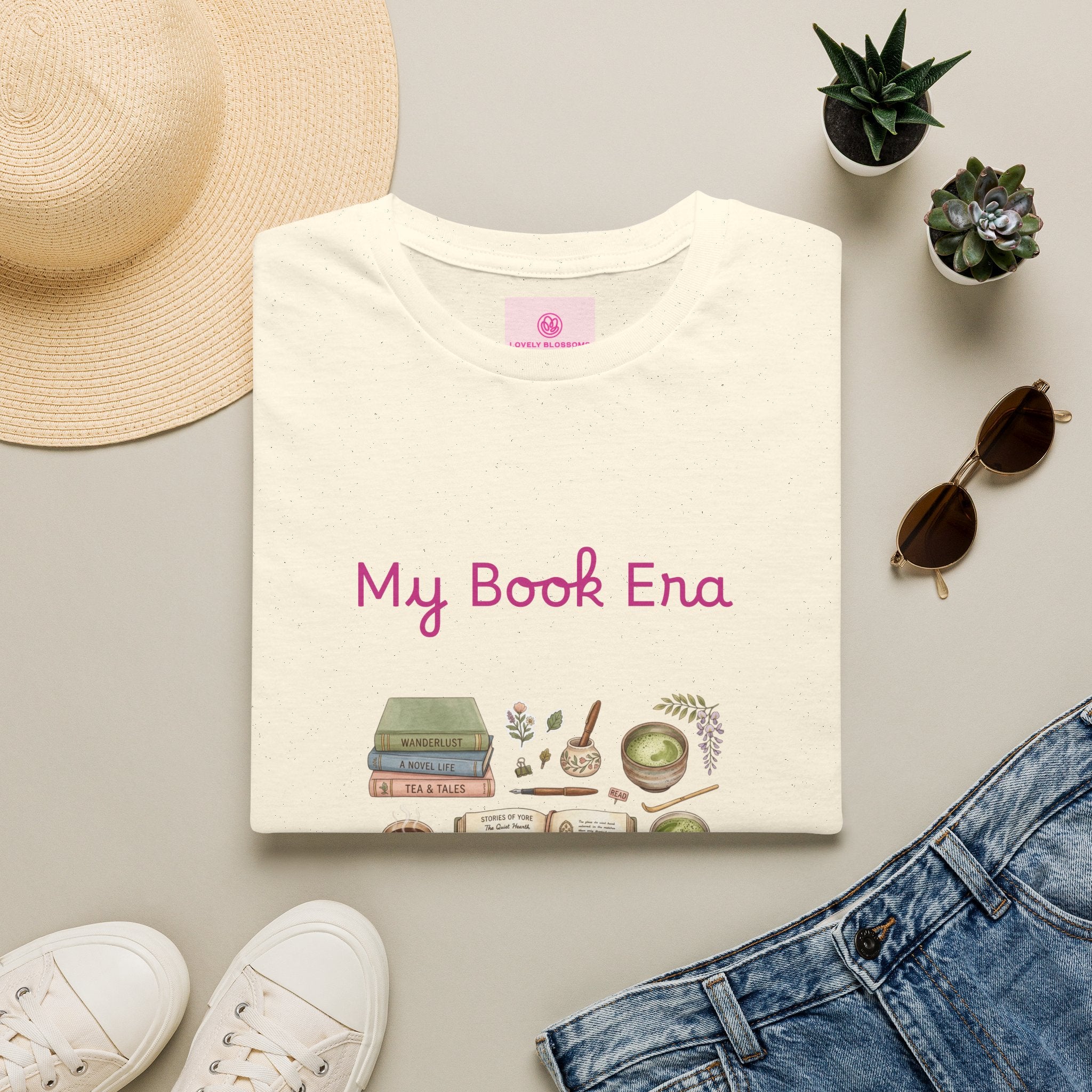 T-shirt with 'My Book Era' design on a light surface with accessories like coffee, books, and matcha.