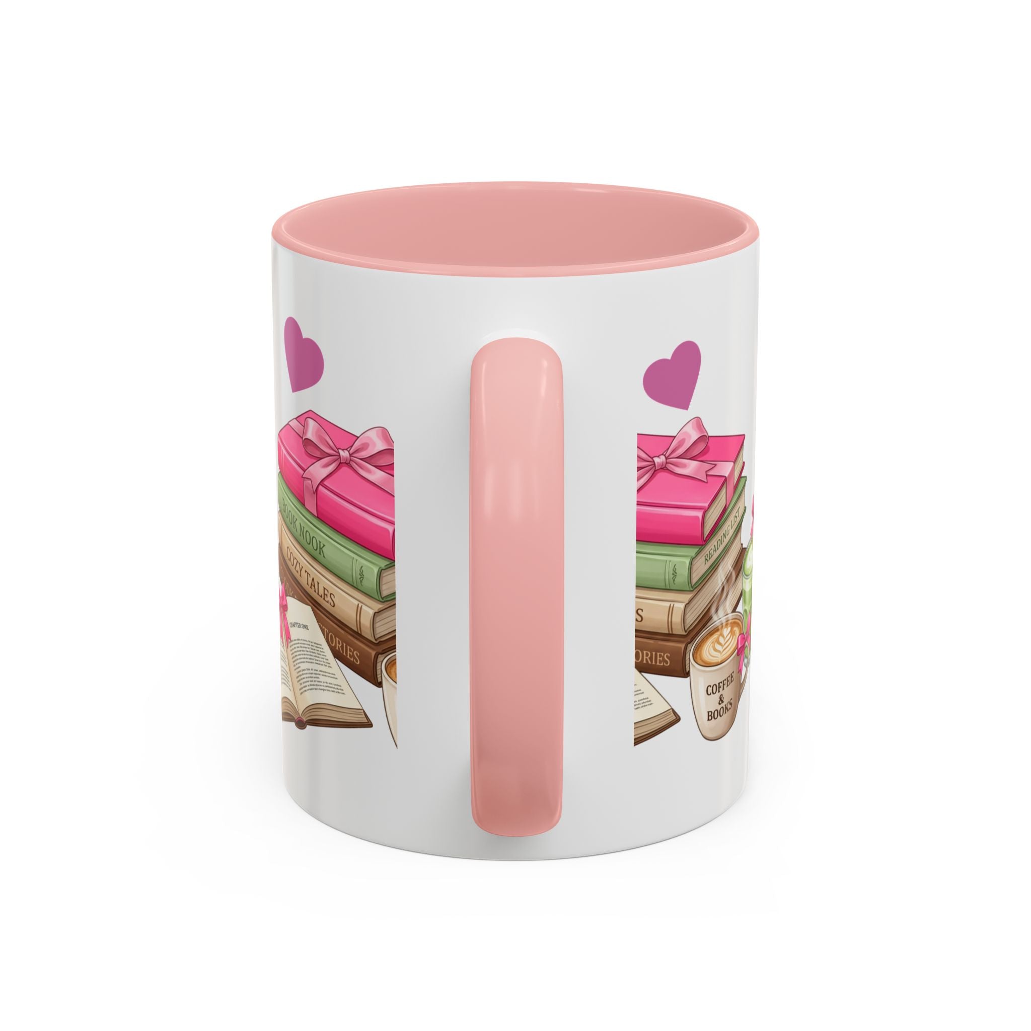 A white ceramic mug with a pink interior and handle, decorated with an illustration of stacked books, pink gift boxes, purple hearts, and a small coffee cup on the side.