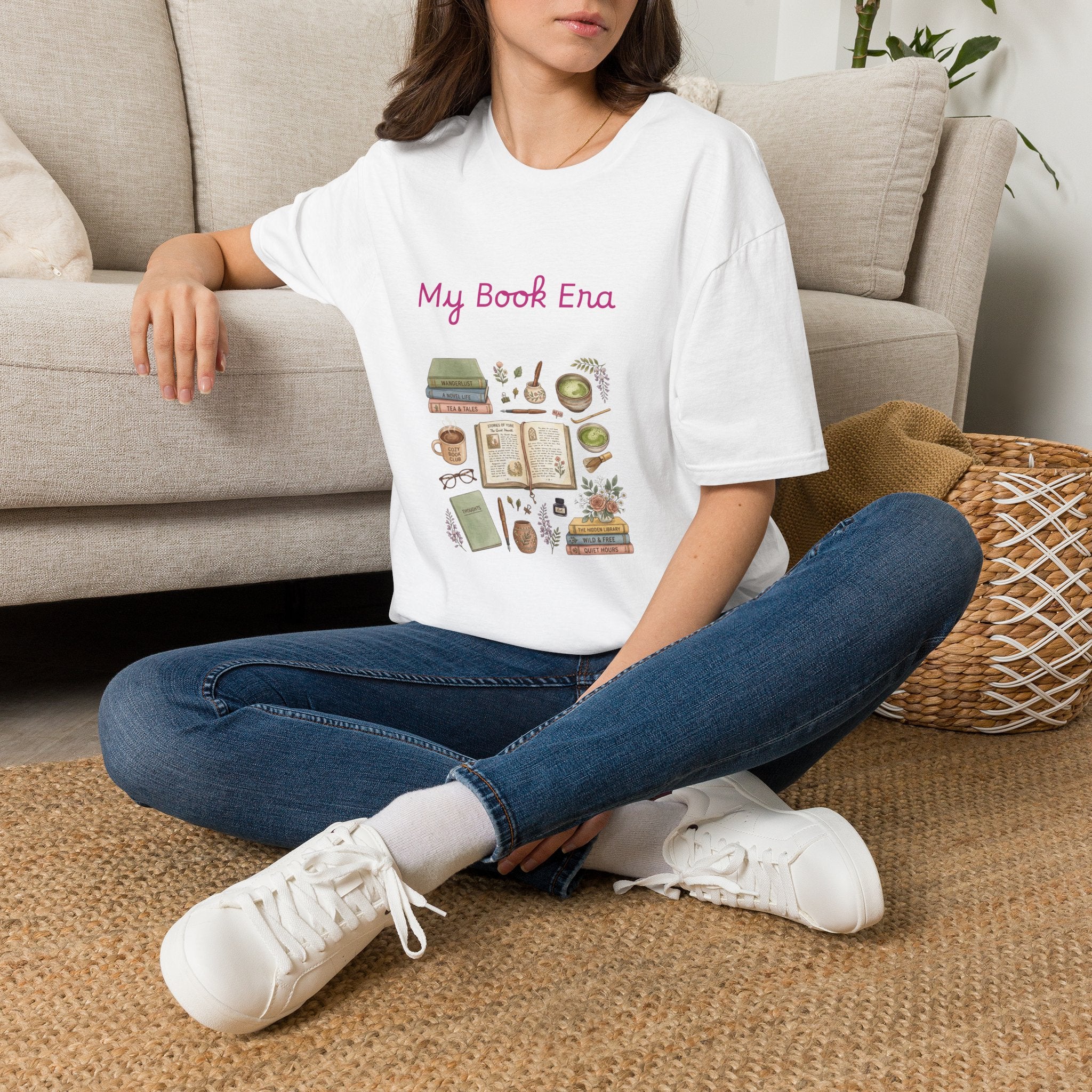 Person wearing a t-shirt with 'My Book Era' design sitting on the floor.