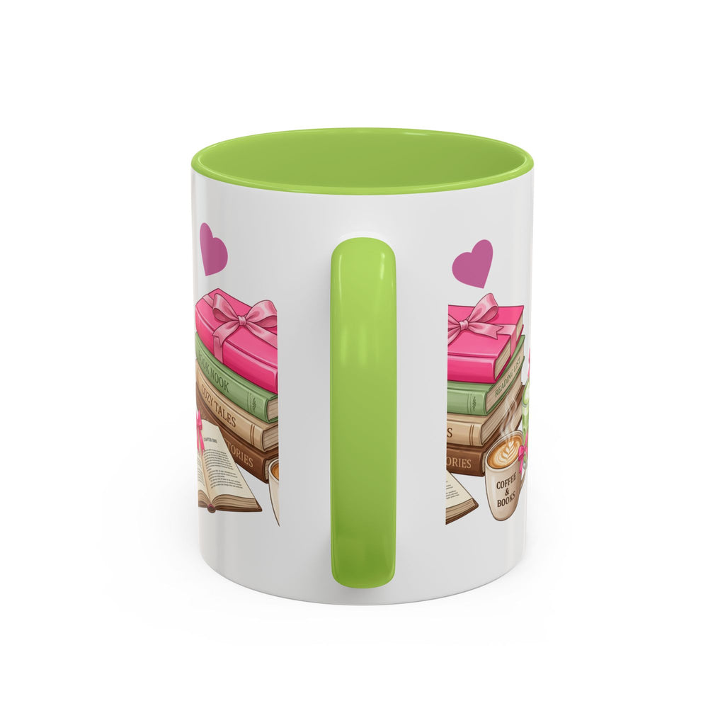 A white ceramic mug with a bright green handle and interior, featuring a printed design of stacked books, pink gift boxes, hearts, and a small coffee cup on the side.
