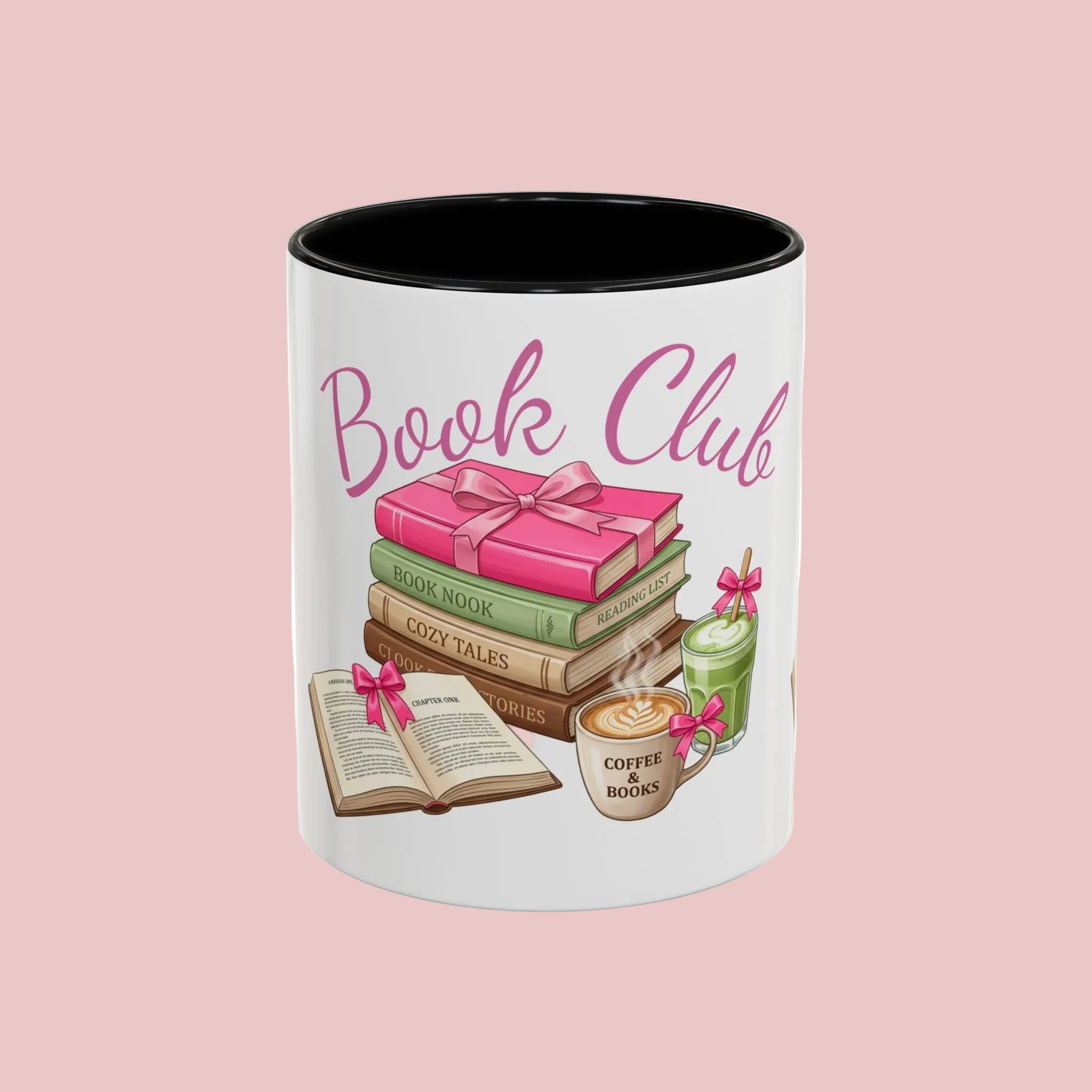 A white ceramic coffee mug with a black interior, featuring a 'Book Club' graphic illustration of stacked books, an open book, a coffee cup, and a green bottle tied with pink ribbons.