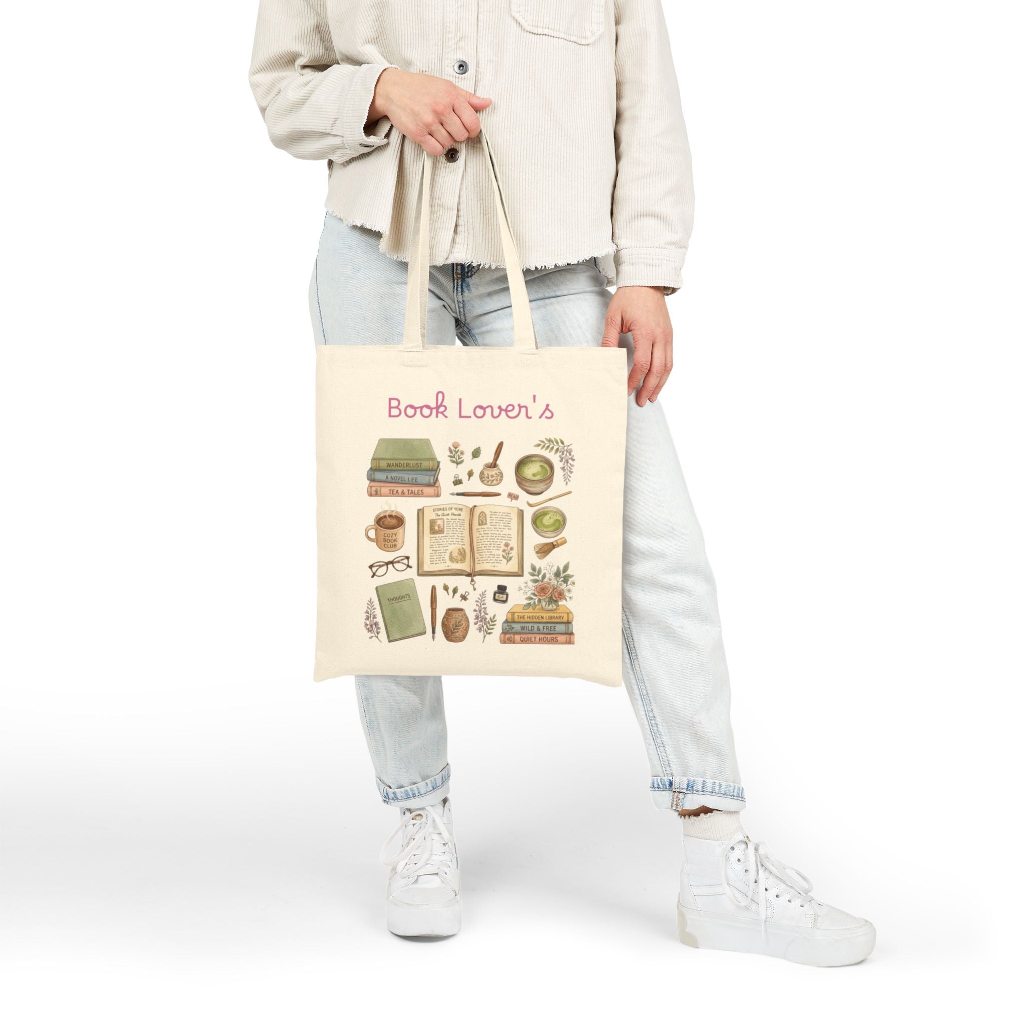 A person wearing a light beige shirt, light blue jeans, and white sneakers holds a cream canvas tote bag with a green and white cartoon matcha cup graphic and the text 'Game, Set, MATCHA.' on a plain white studio background.