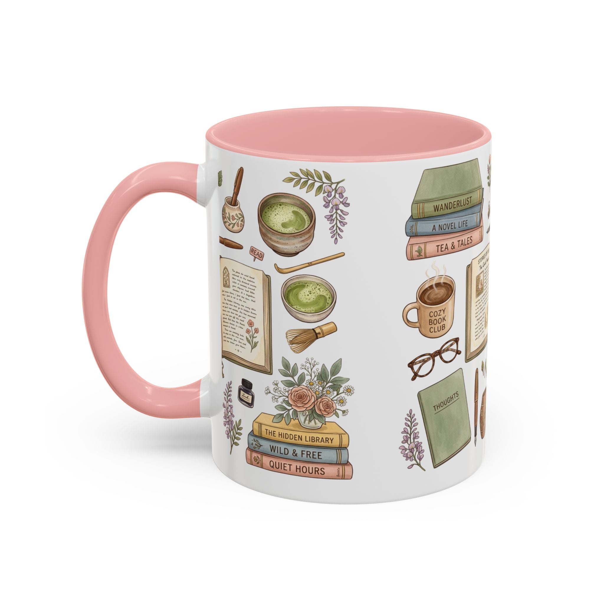 A white ceramic mug with a pink handle and pink interior, decorated with illustrated book and tea-themed graphics including books, glasses, a cup of matcha, and floral accents.