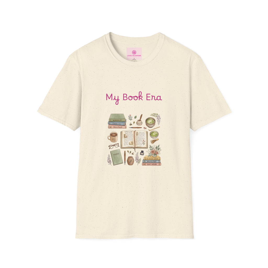 An off-white short-sleeve crewneck t-shirt featuring a 'My Book Era' graphic print on the chest. The graphic includes pink text and a collection of illustrated books, notebooks, coffee cups, and books with flowers.