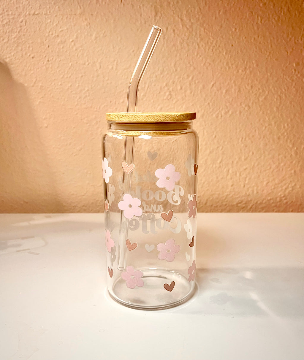 16 ounce glass drink cup with the words “fueled by Books and Coffee,” at the center of the front side cup. There are also pink cherry flowers and light brown small hearts scattered around the cup as the design. The words also contains these same color tones. Overall the cup is a very cute, girly and a great asset to have when reading a book with your favorite drink. 