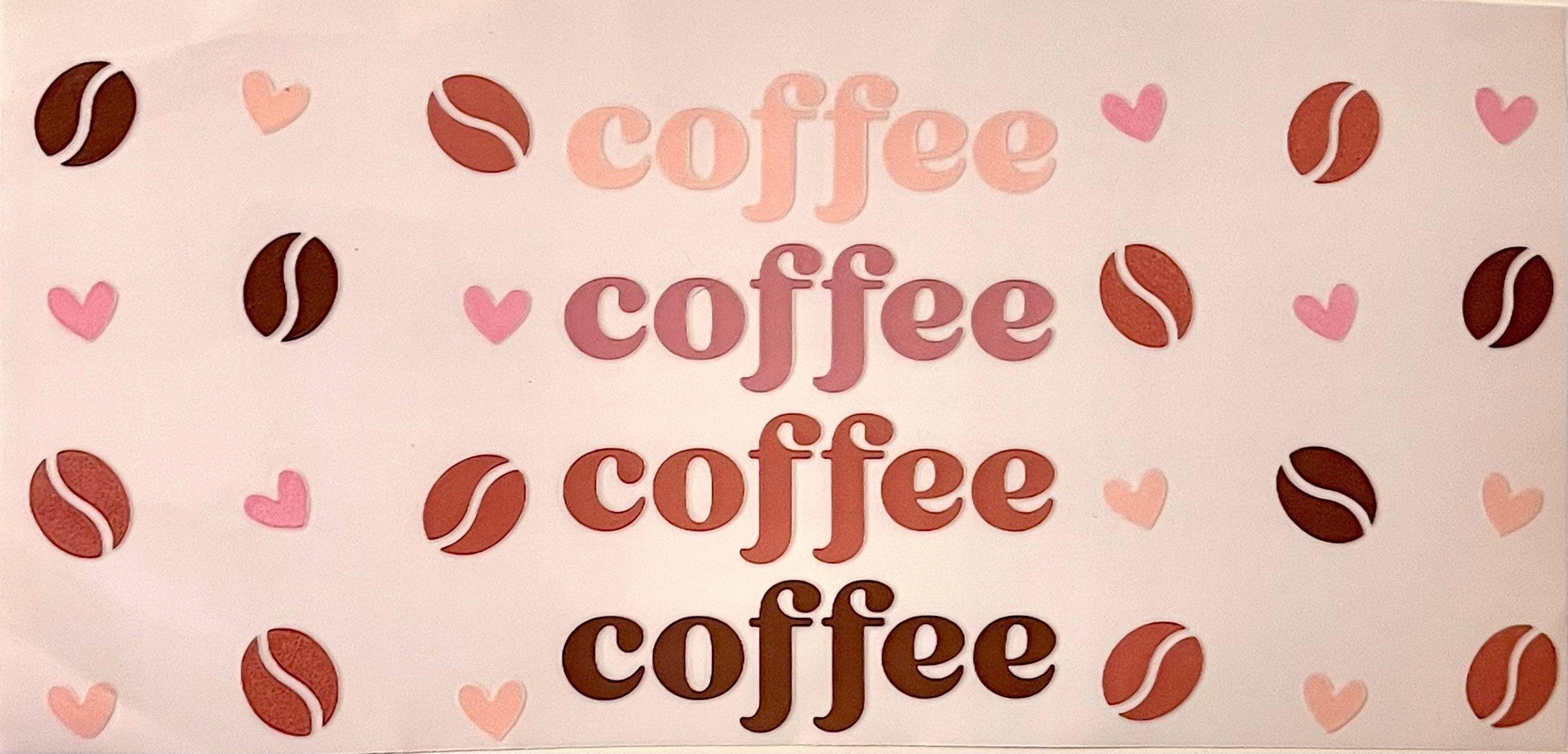 A repeating pattern of the word 'coffee' in various pink, mauve, and brown font styles, interspersed with coffee bean and pink heart motifs on a blank background.