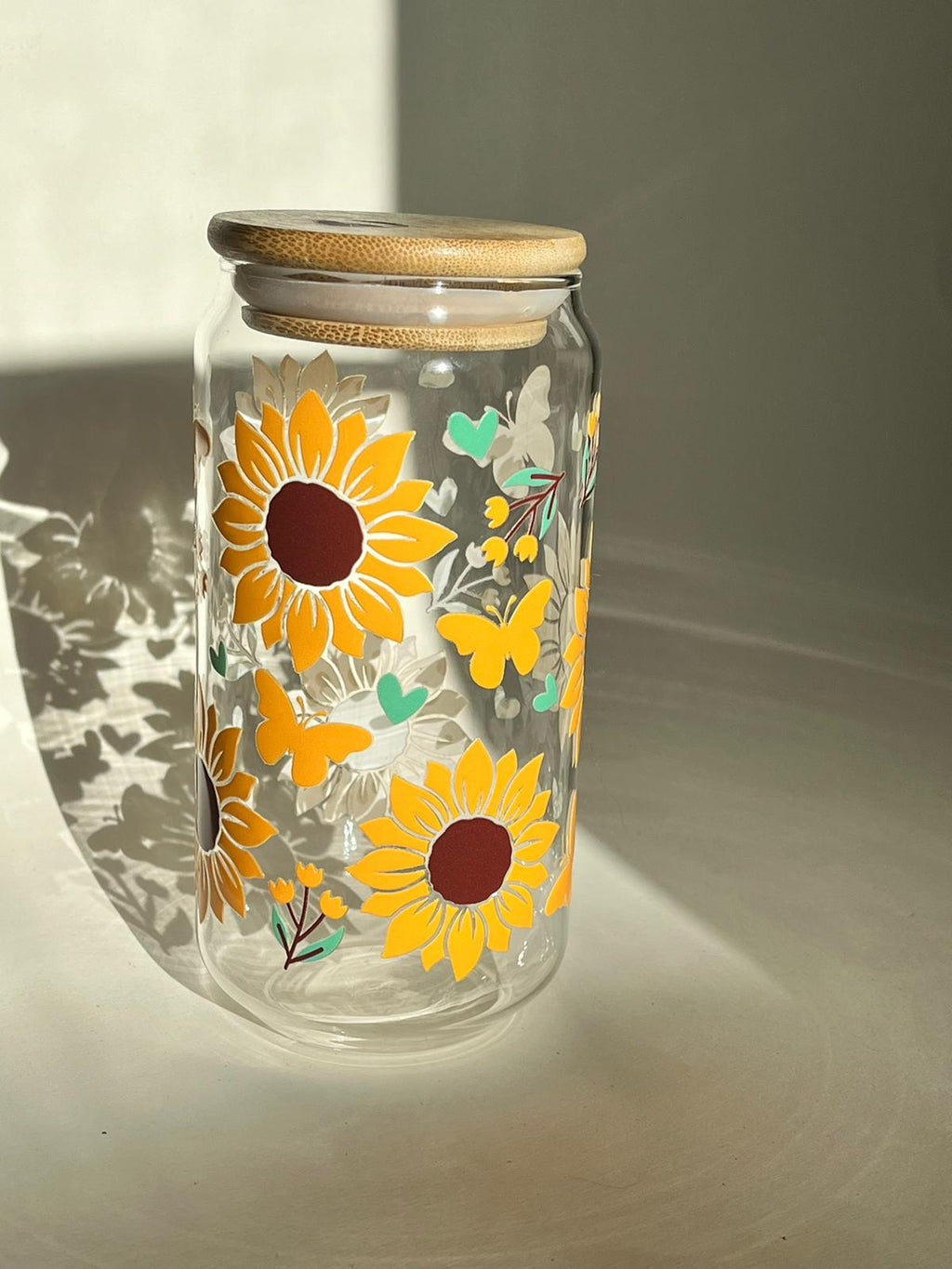 Lovely Blossoms 16oz borosilicate glass cup with sunflower and heart print, bamboo lid, and glass straw.